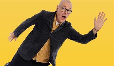 picture of colin murphy the comedian on a yellow background