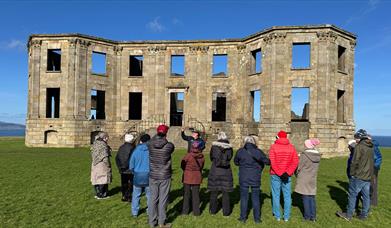a group enjoy a tour on the grounds of Downhill Demesne