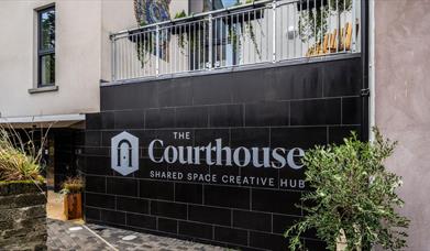 The Courthouse logo on a black tile wall, Bushmills.