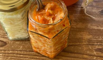 A glass jar filled with fermenting ingredients