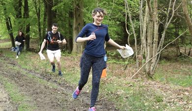 a group of people orienteering in the forest