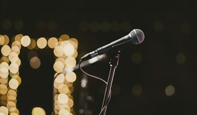 a microphone with blurred lights in the background