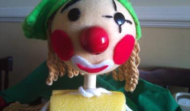 close up for a rod puppet's face that looks like an elf.