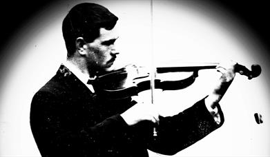 black and white image of Sam Henry playing the violin