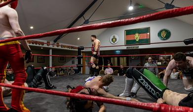 A number of wrestlers performing in ring at the Ballymoney Legion Hall.