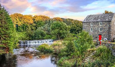 the River Bush flows outside an old stone building on the site of the salmon fisheries in Bushmills