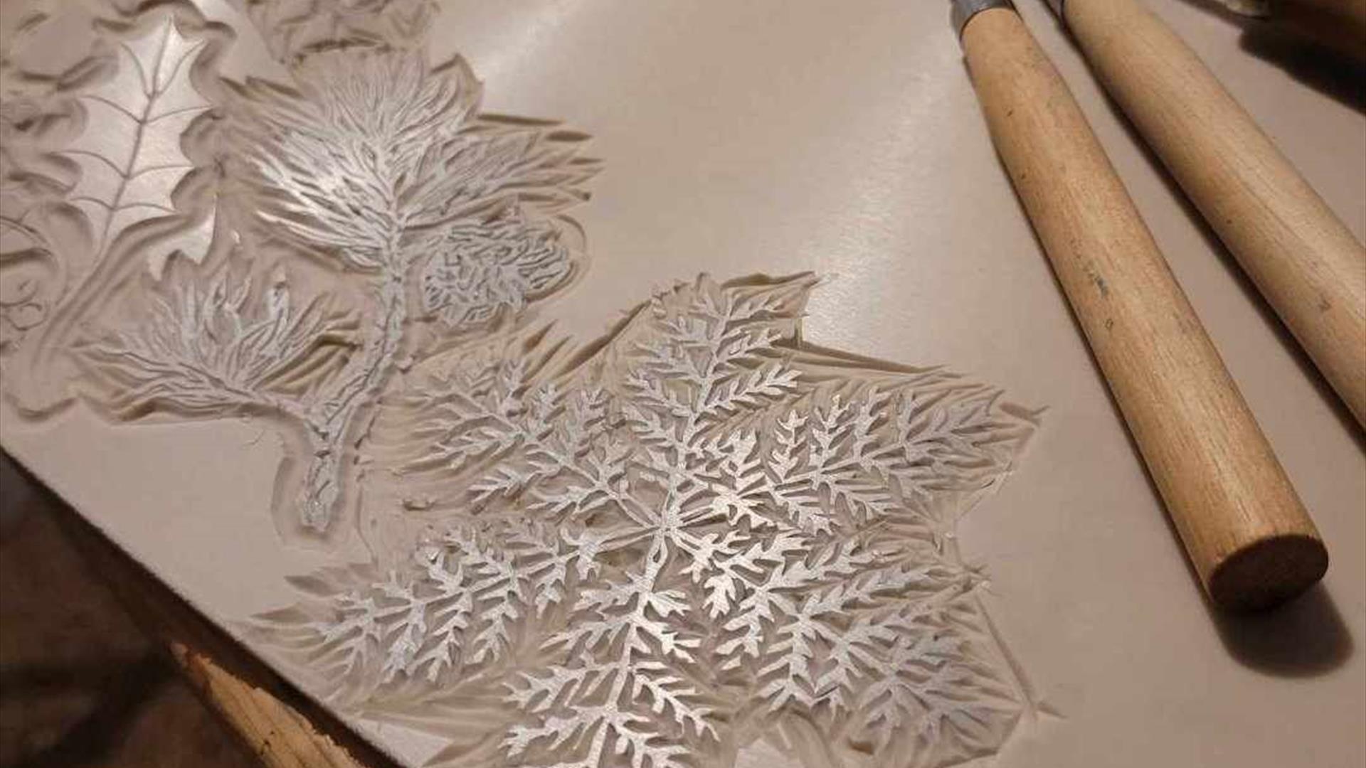 print making materials carved into snowflakes and mistletoe