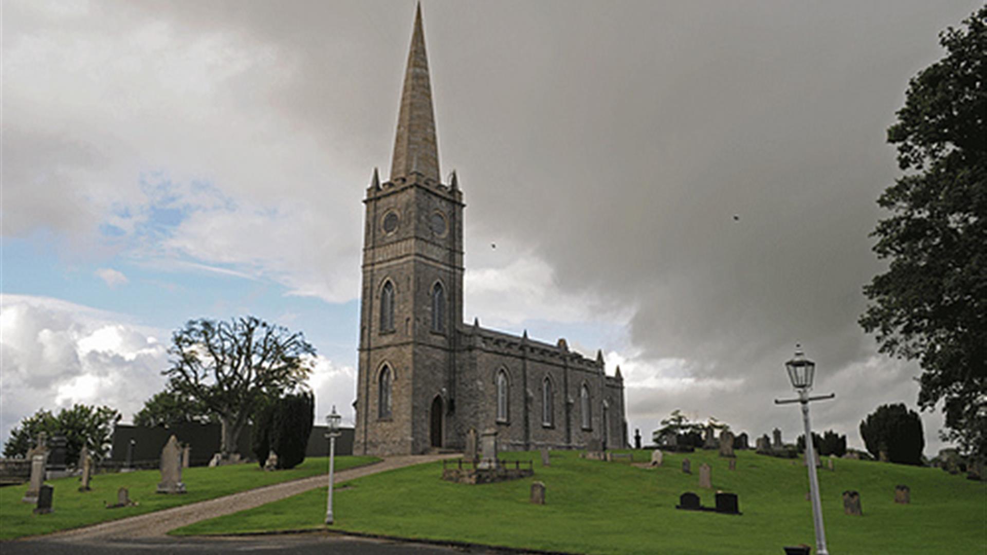 Tamlaght Finlagan Old Church, grey clouds and trees in the background.