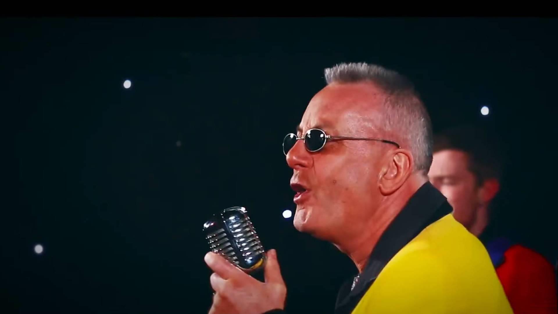 Singer in a yellow jacket with a vintage chrome microphone