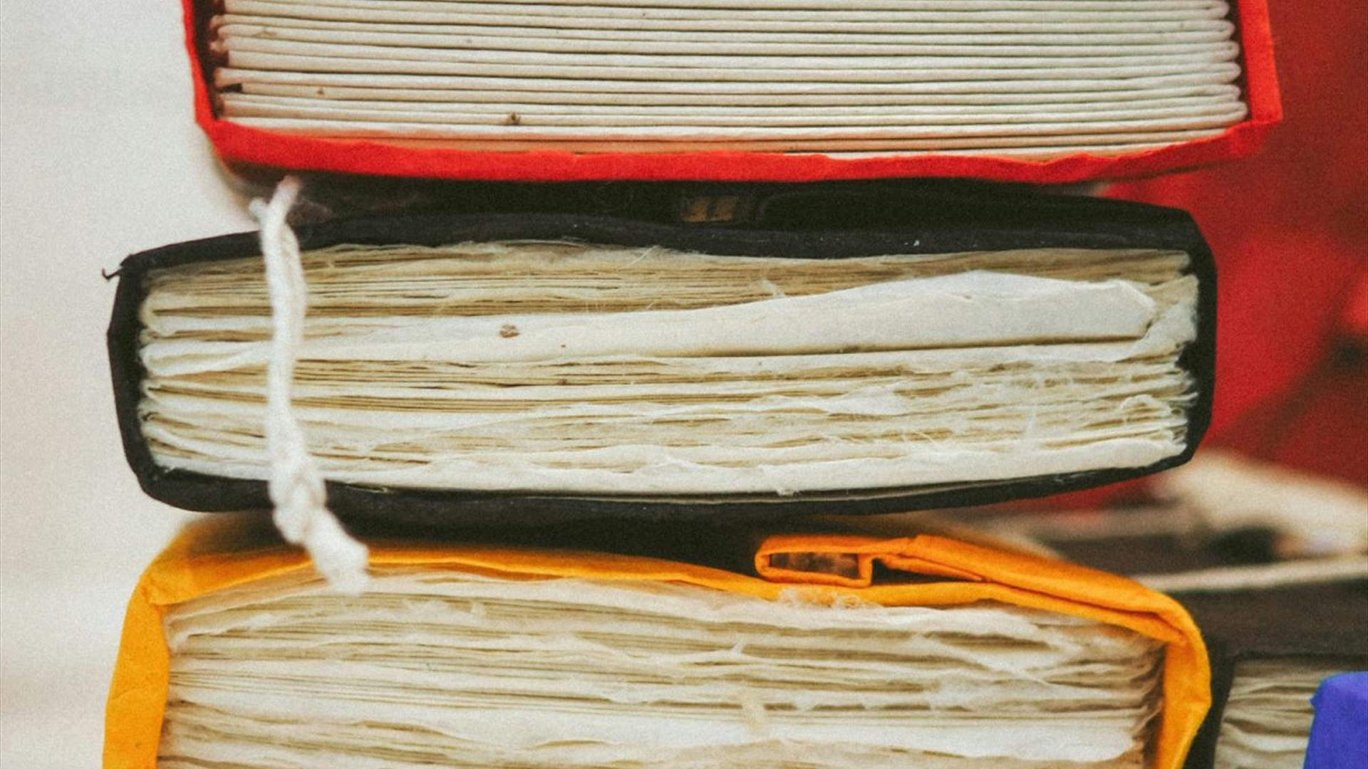 a stack of books with custom leather bindings