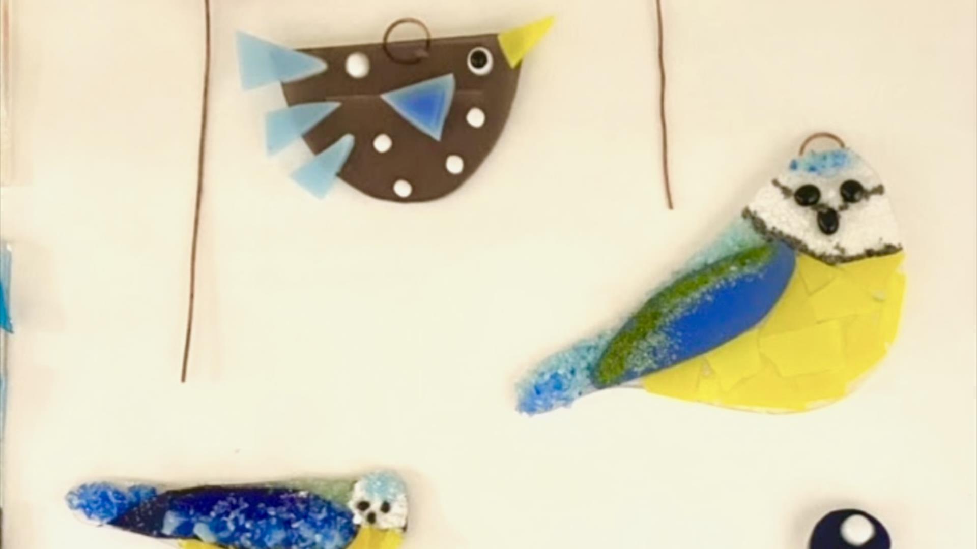 Various glass birds, all painted to resemble different species.