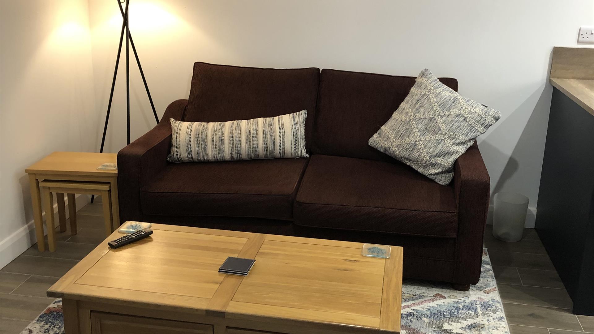 Living room with sofa, coffee table and lamp at The Heagry