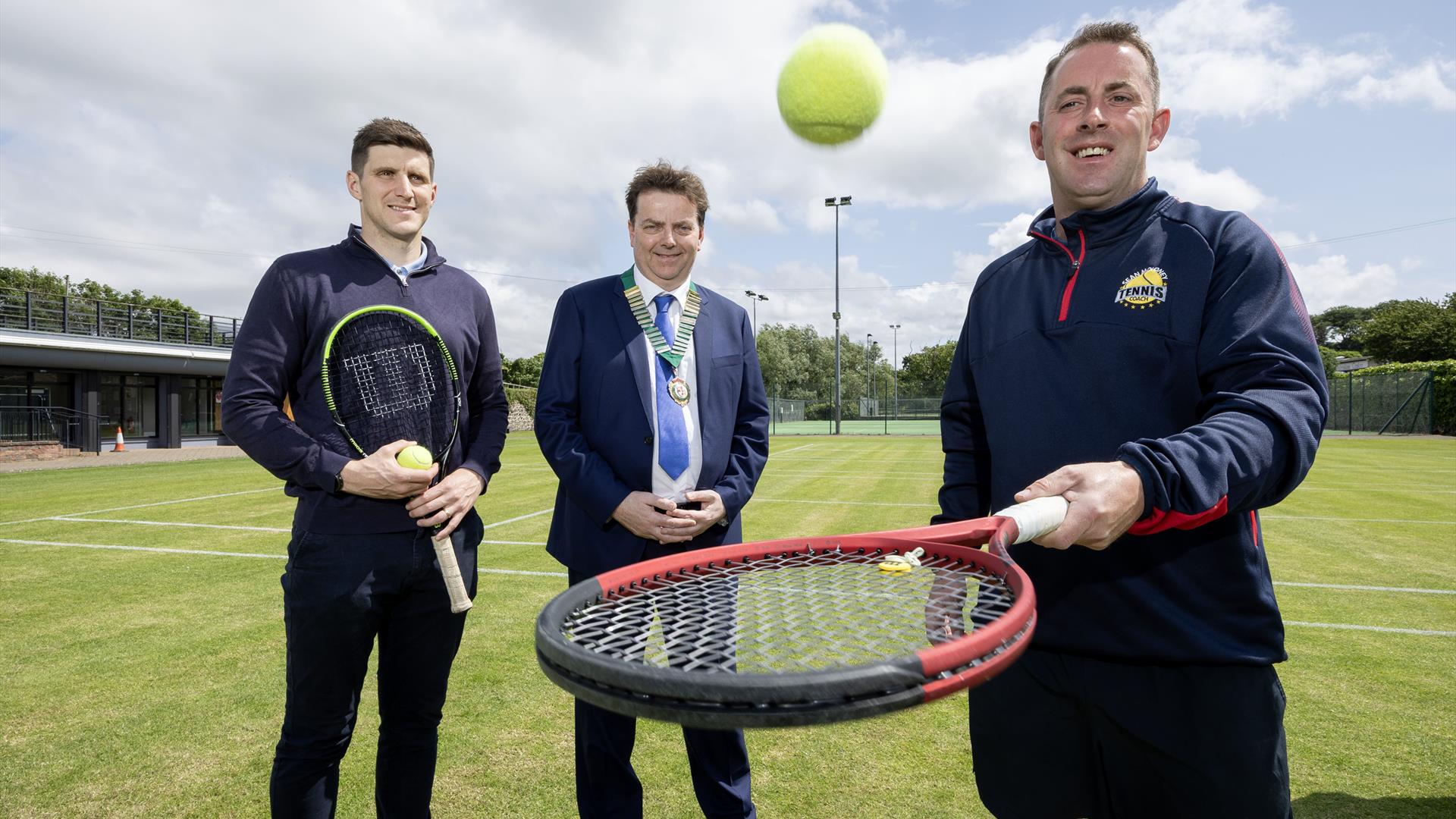 The organisers of Country Antrim Tennis Championships stand holding rackets