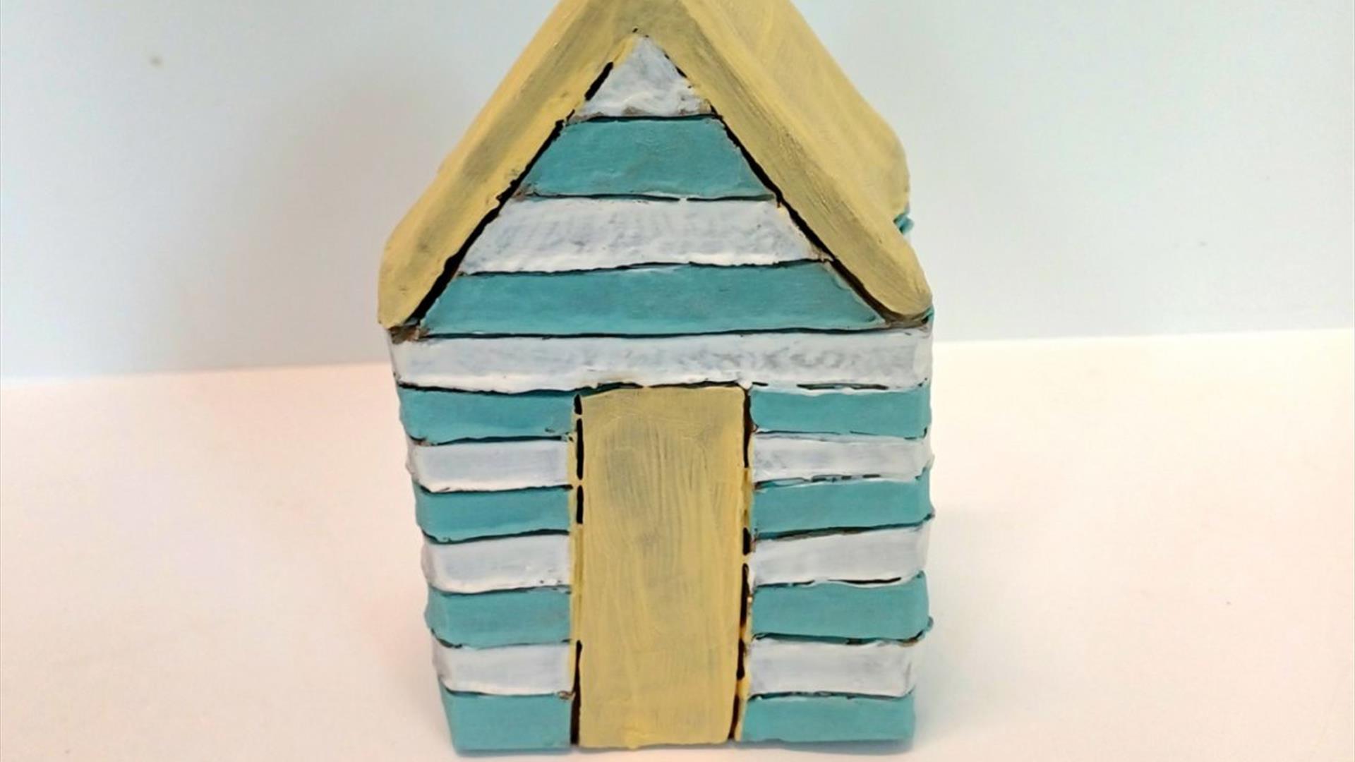 a clay beach hut sculpture
