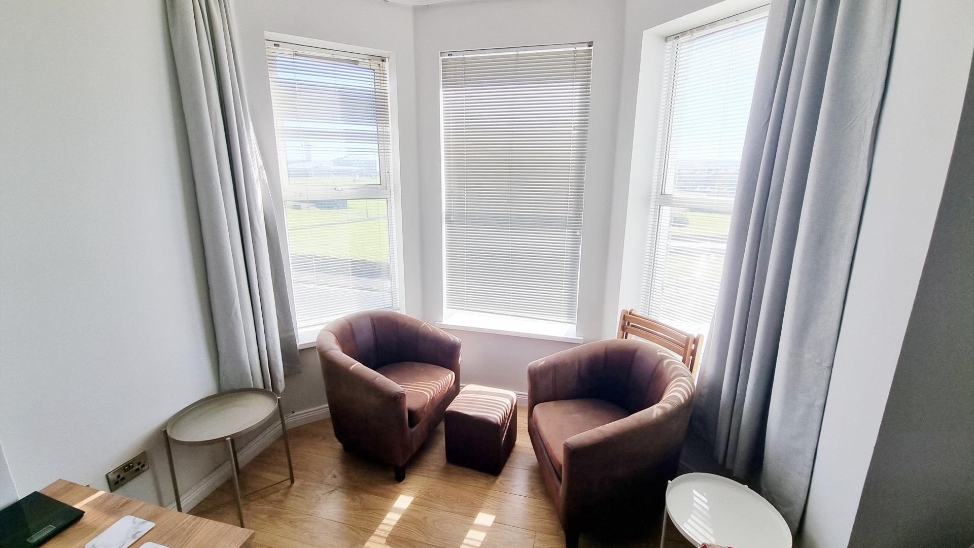 Table and chairs seating area by window