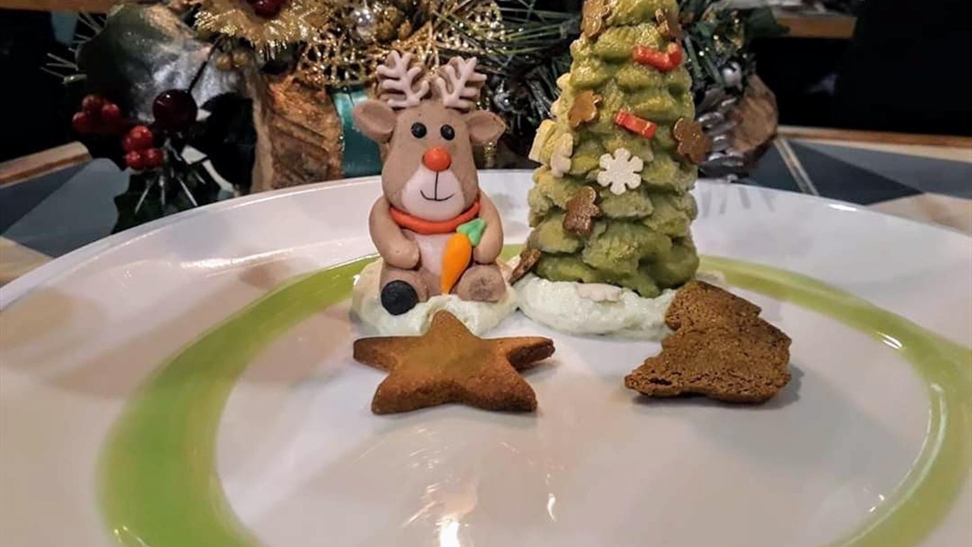 a festive dessert which features gingerbread biscuits and desserts shaped as a reindeer and a christmas tree