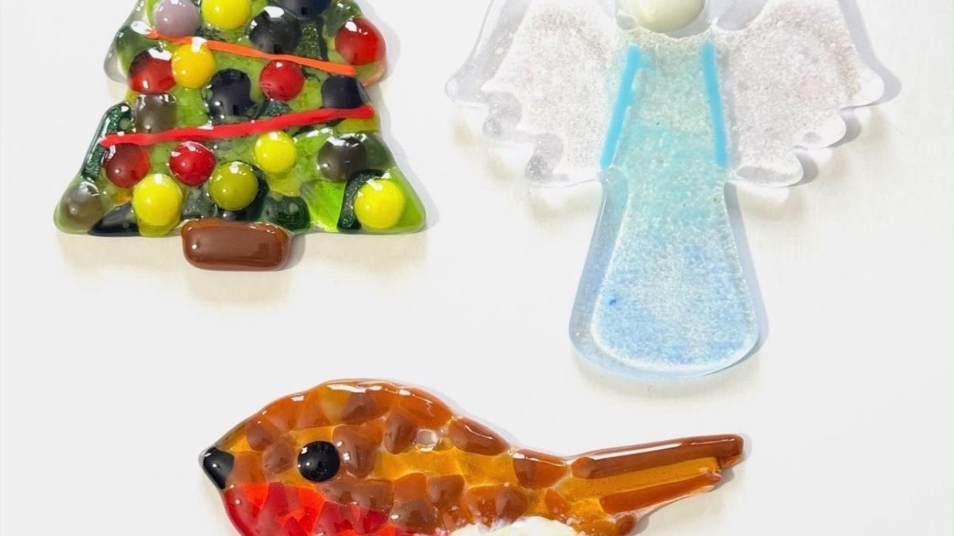 various fused glass decorations including a christmas tree, a robin and an angel