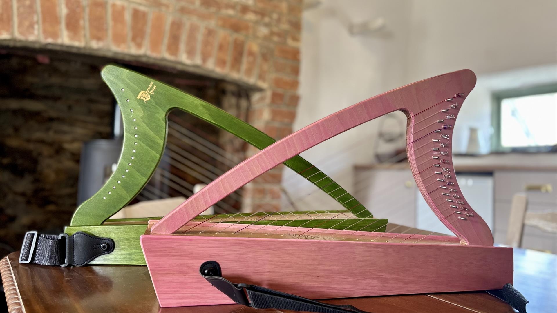 small irish harps sit on a table top inside a converted barn