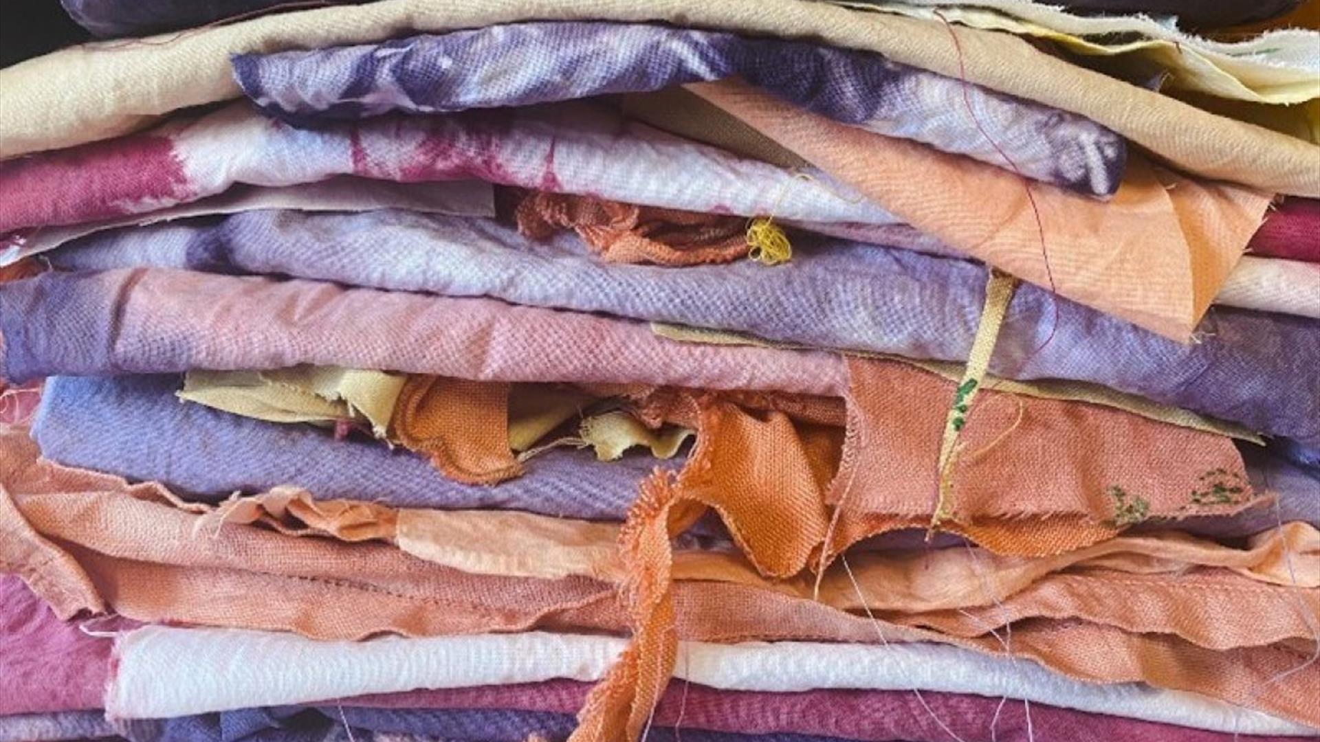 stacked textiles coloured a variety of natural colours