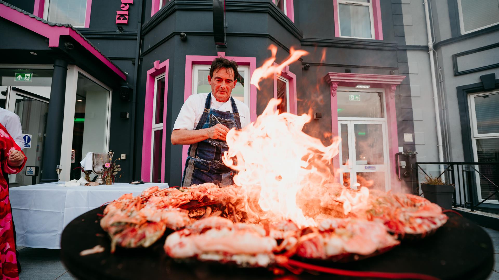 Stephane Delourme at Elephant Rock Hotel, cooking up a plate of seafood with an open flame.