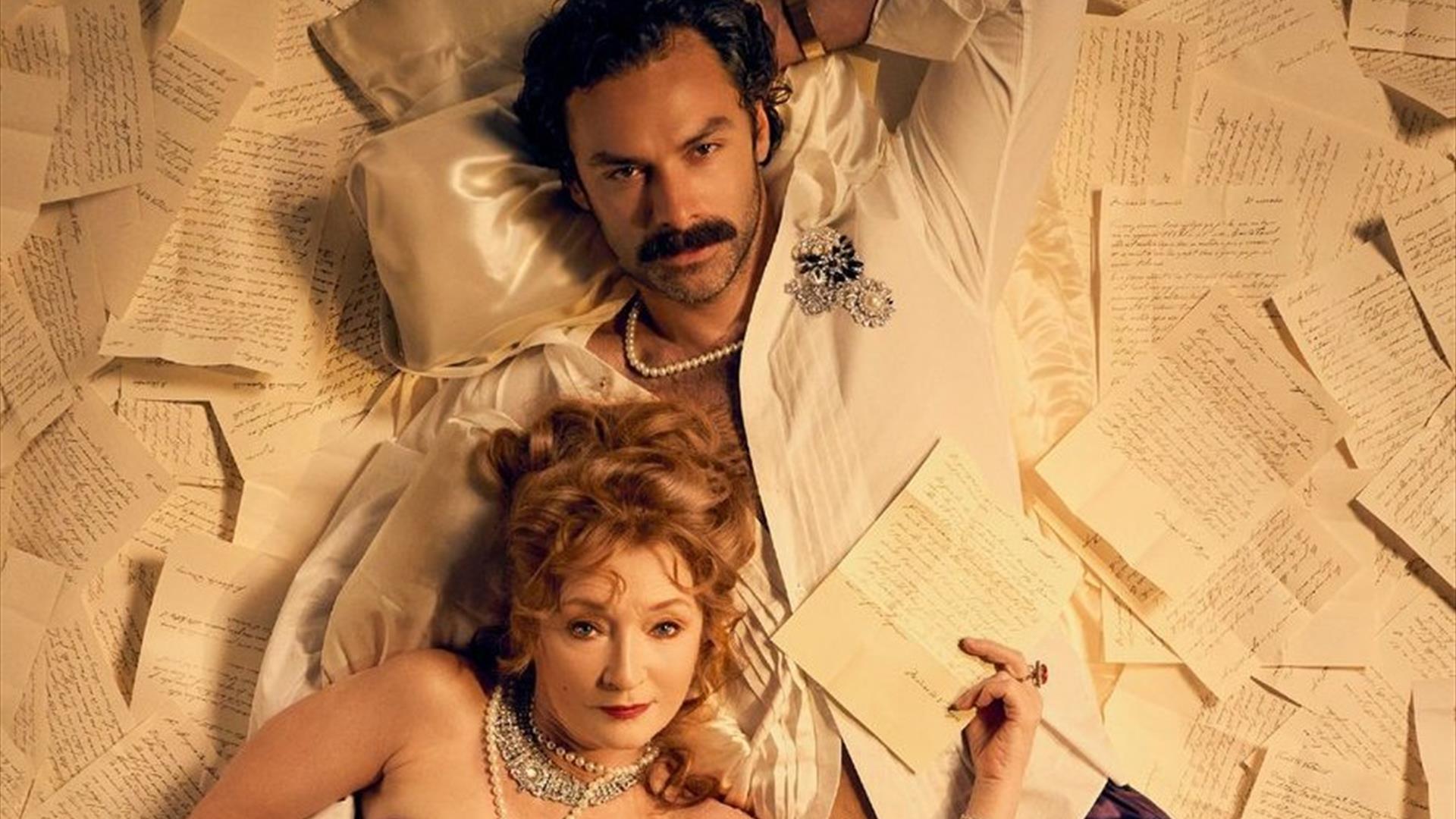 a man and a woman lying among sheafs of loose paper