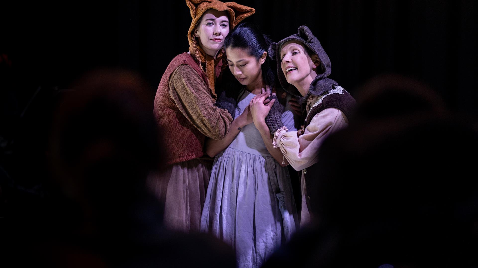 image of the character the bear the foxand the child in a group hug.