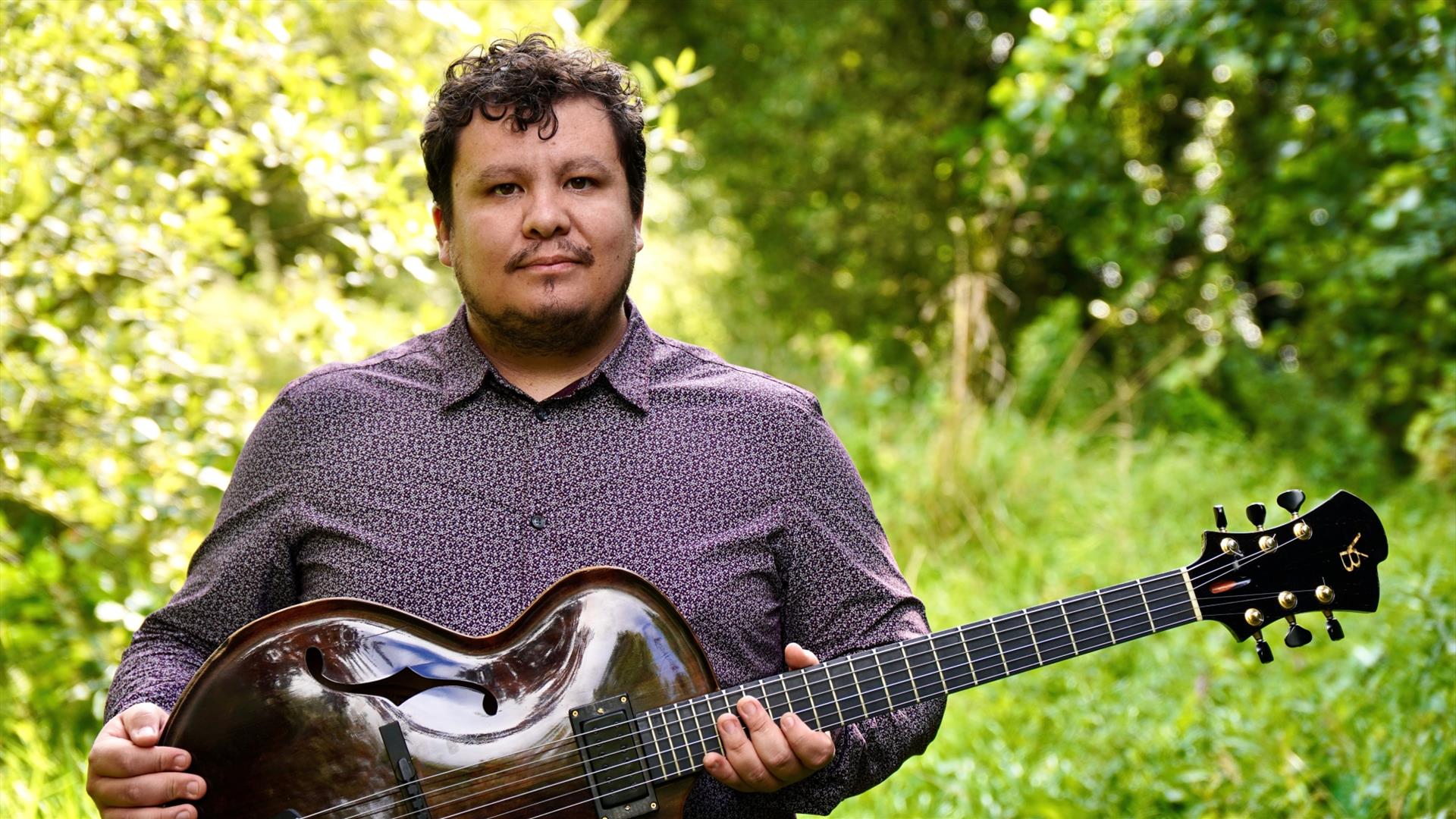 Man holding a traditional string instrument.