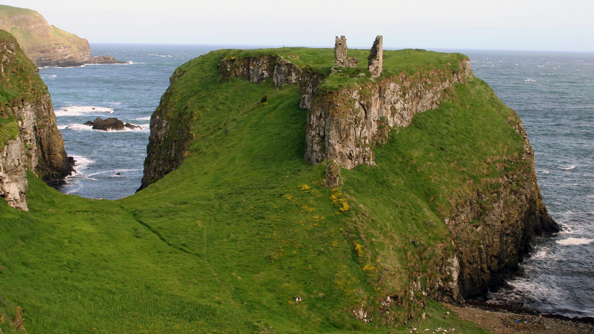 the ruins of Dunseverick Castle on a cliff along the Causeway Road