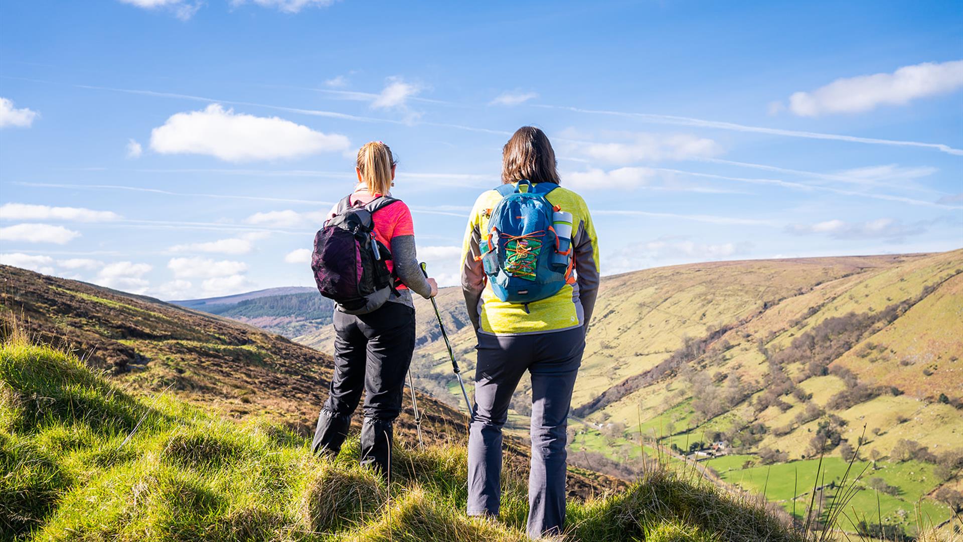 2 hikers take in the views of the surrounding countryside