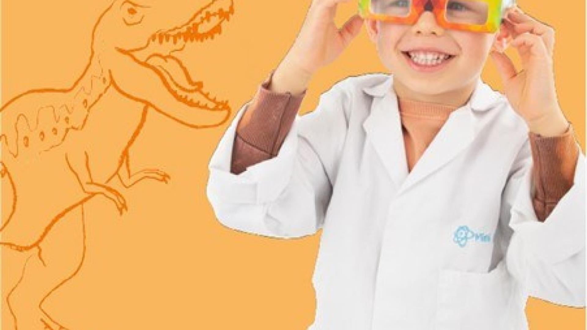 A smiling child in a white professor coat.