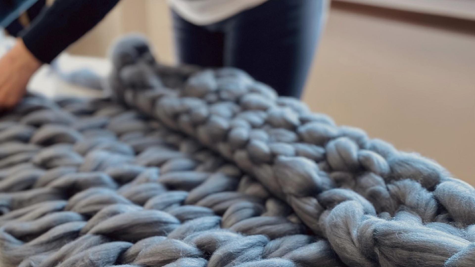 A grey, arm knitted throw