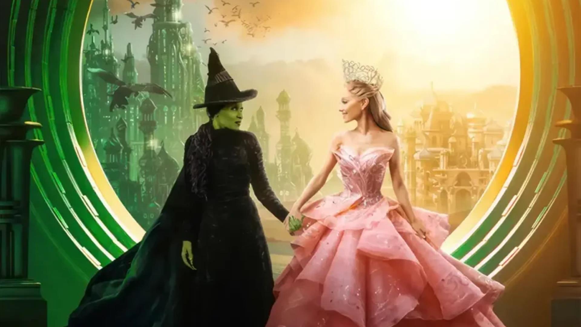 A scene from Wicked with the two main characters Elphaba and Galinda holding hands.