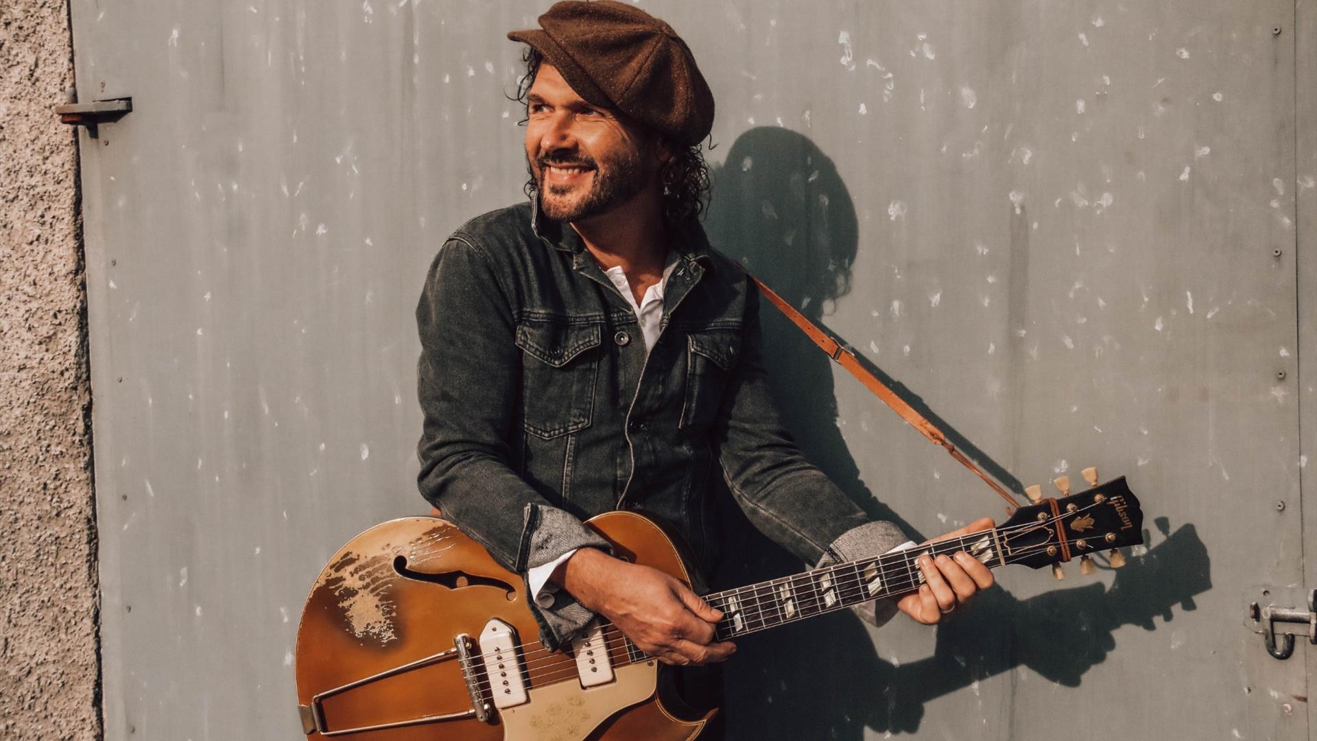 singer songwriter Brian Houston pictured with guitar