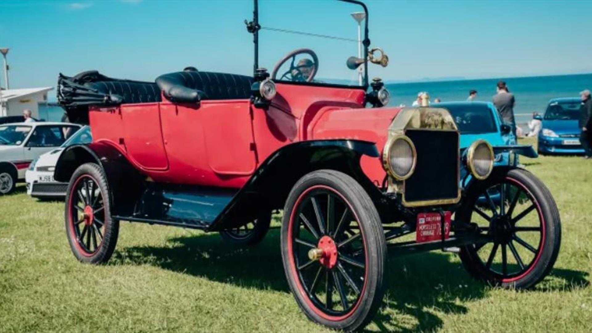 An old red vehicle with its top down