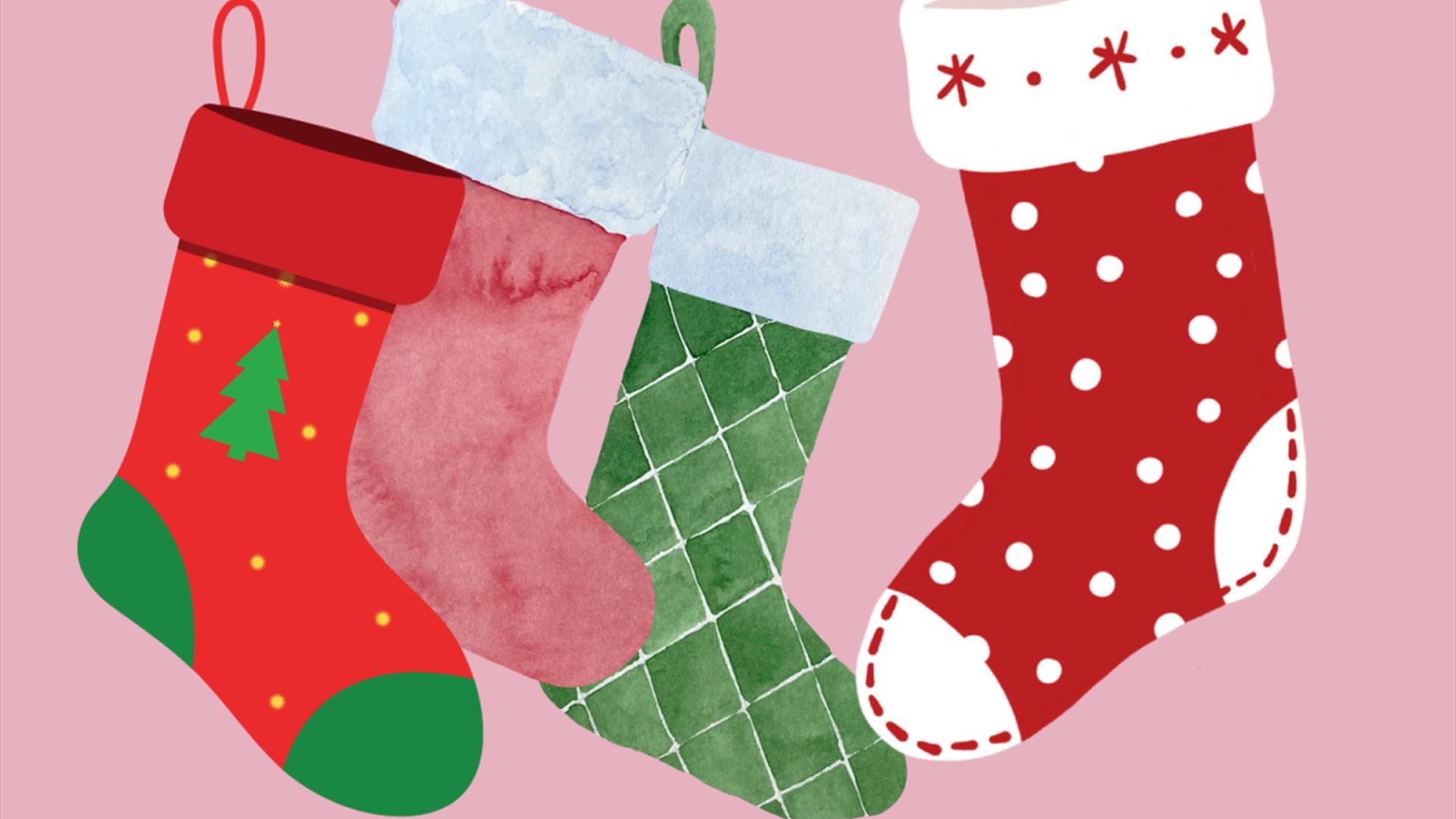 colourful christmas stockings on a pink background