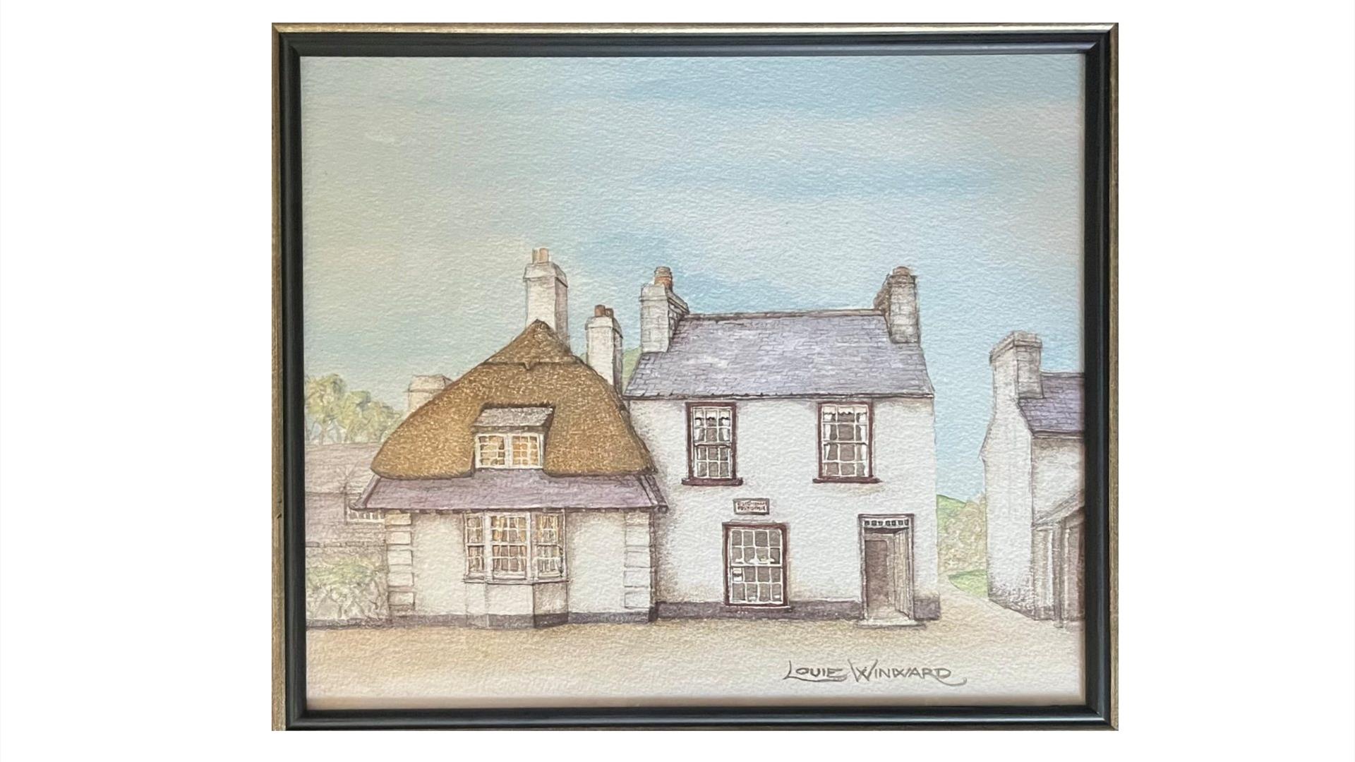 a framed drawing of a traditional irish home with a partially thatched roof