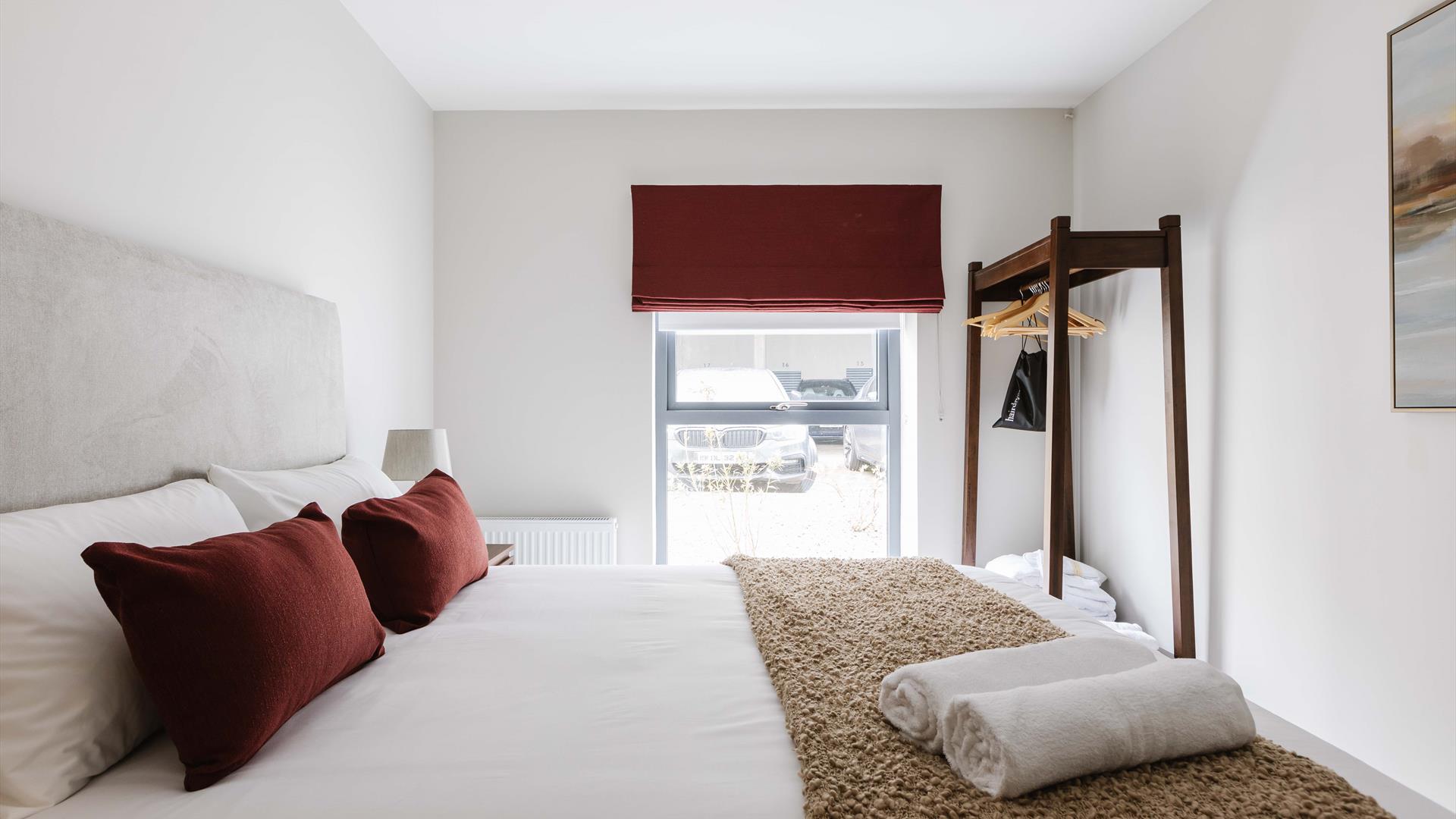 interior of bedroom at DB Stays 'The Cove' featuring a double bed and standalone clothes wrack