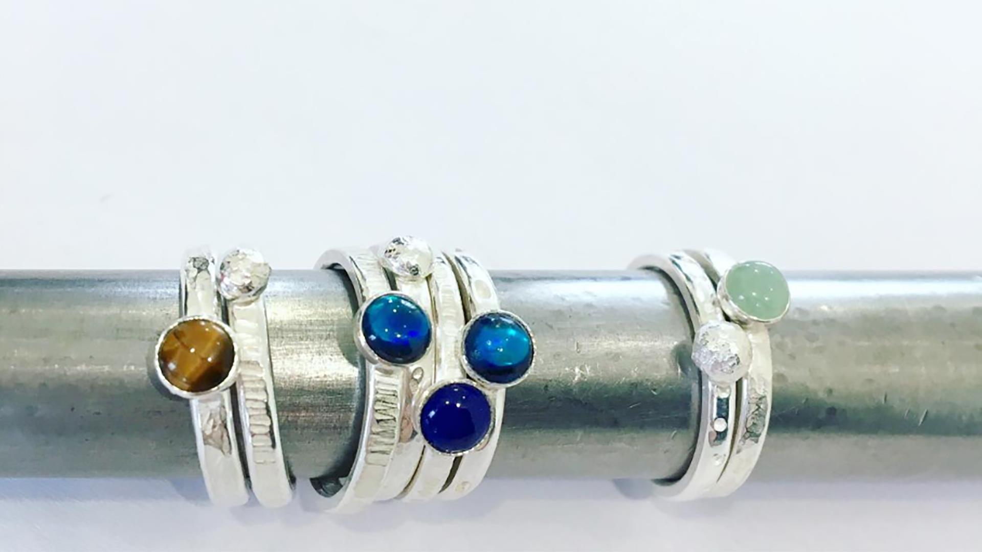 a selection of stacking rings set with brightly coloured gem stones