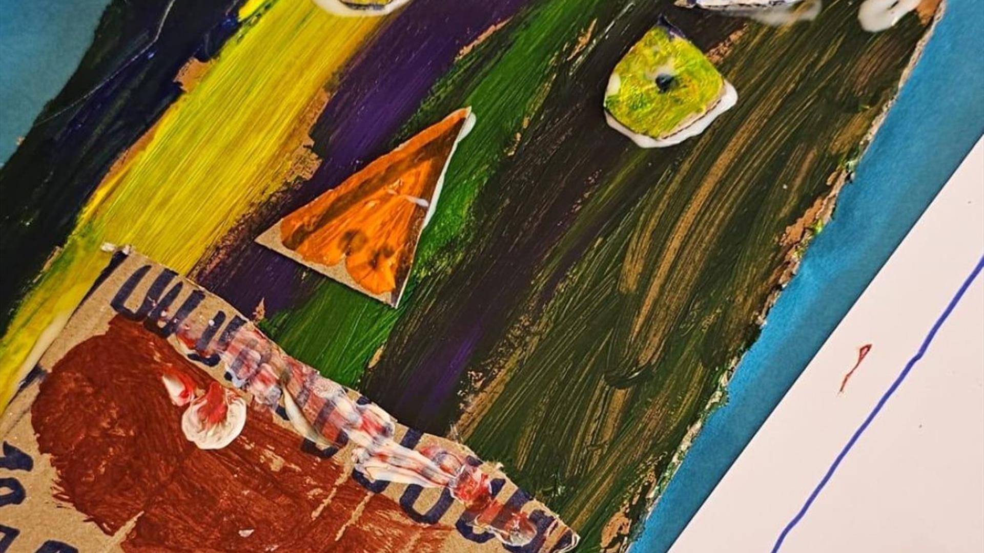 a multi-coloured mask being painted by a child