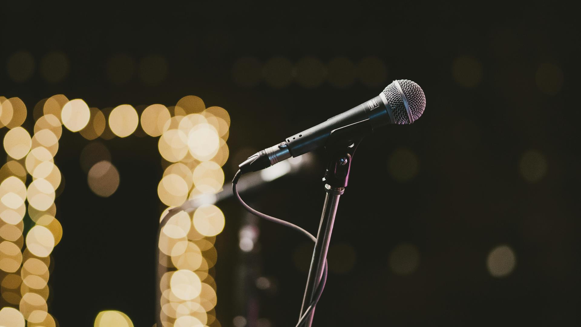 a microphone with blurred lights in the background