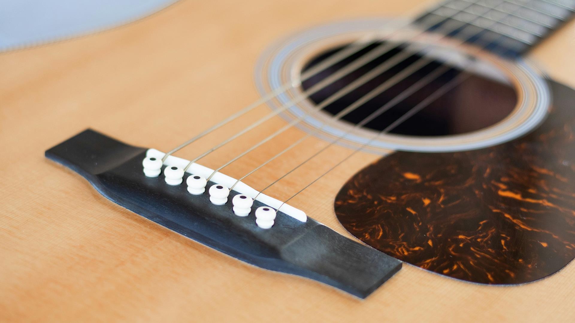 Close up photograph of an acoustic guitar