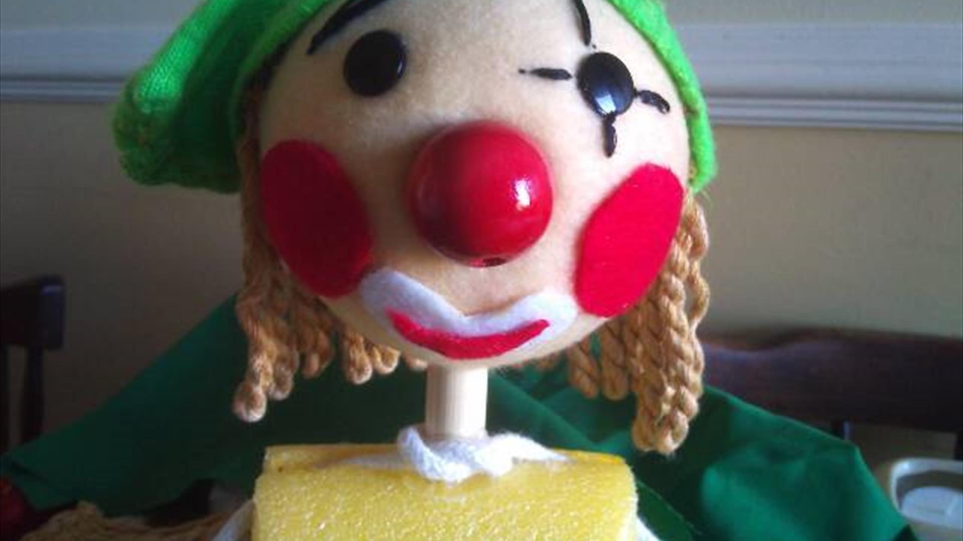 close up for a rod puppet's face that looks like an elf.