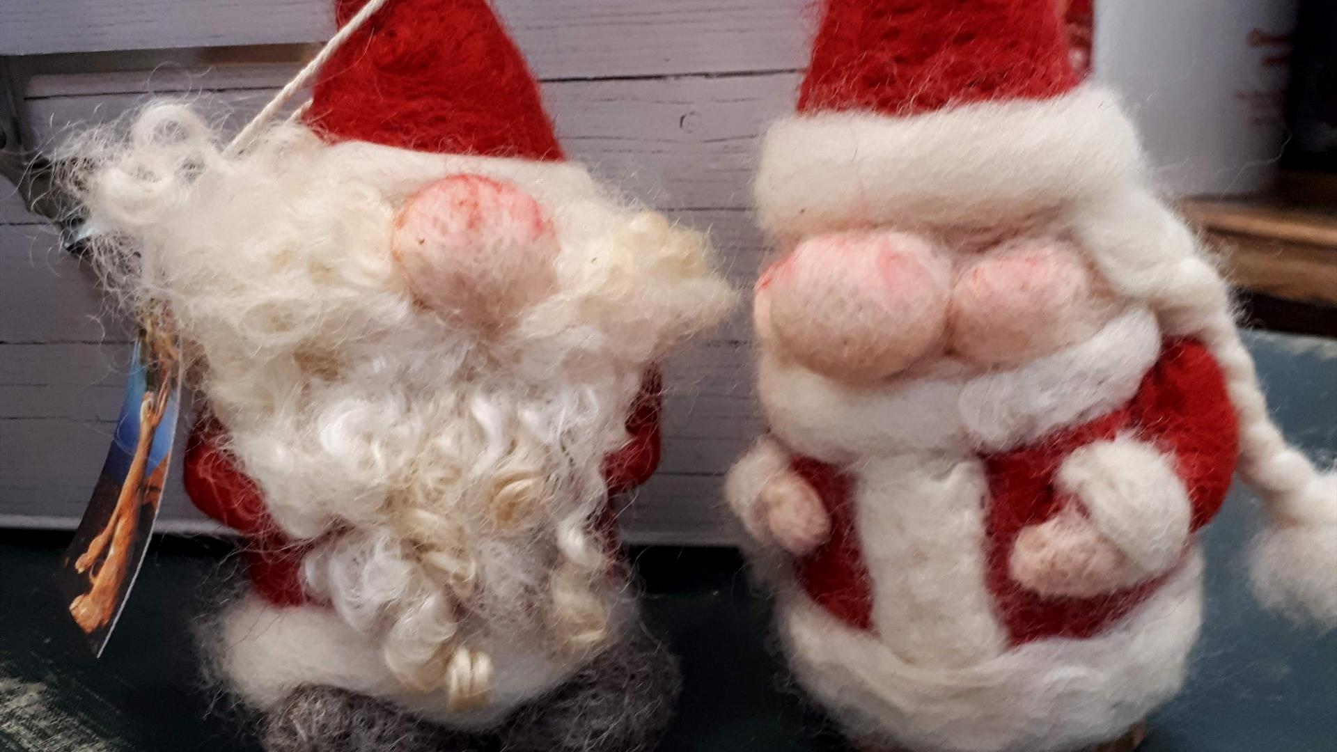 close up picture of 2 felted santa claus figures