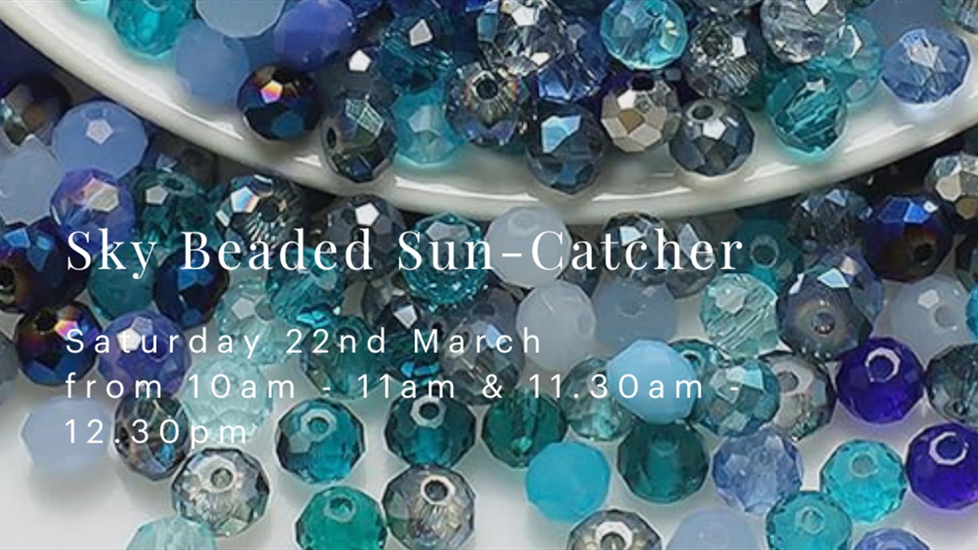 An image with many blue, turquoise and azure beads spilling out from a white porcelain bowl. White text on the front reads "Sky Beaded Sun Catcher" on