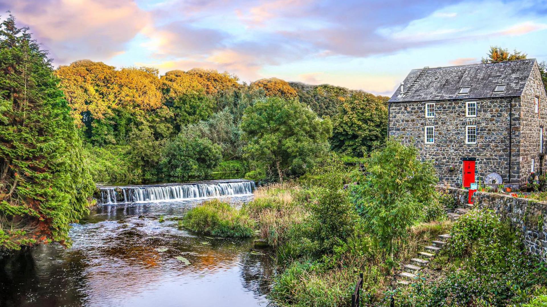 the River Bush flows outside an old stone building on the site of the salmon fisheries in Bushmills
