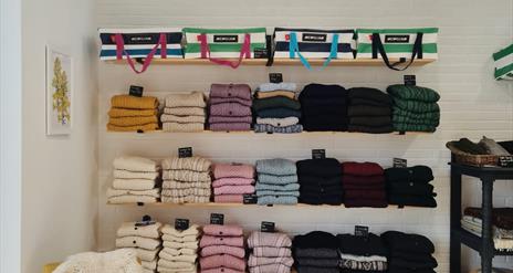 shelves at Bramble Green holding a range of colourful knitwear