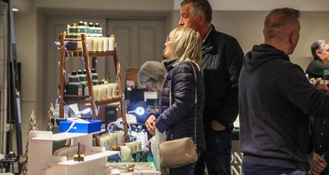 People browsing indoor market stalls