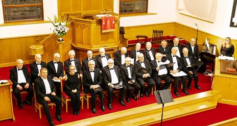 image of Ballymoney & District Male Voice Choir seated in a church