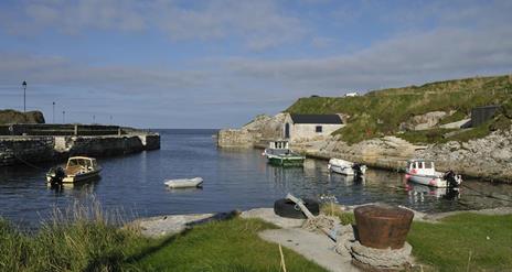 Small boats docked at Ballintoy Harbour