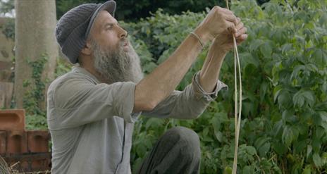 A man carefully splitting nettles.
